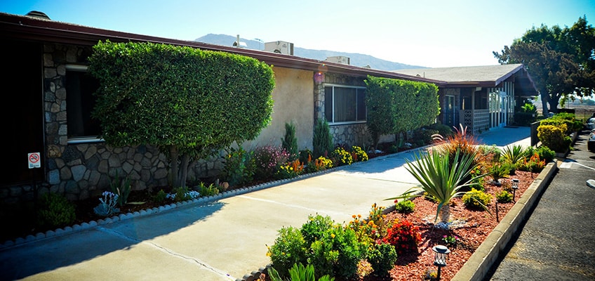 Side of Jurupa Hills, sidewalk to entrance surrounded by colorful plants