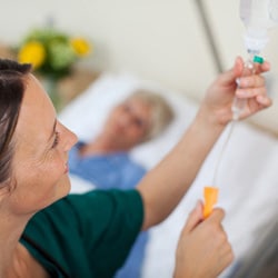 A nurse fixing an IV.